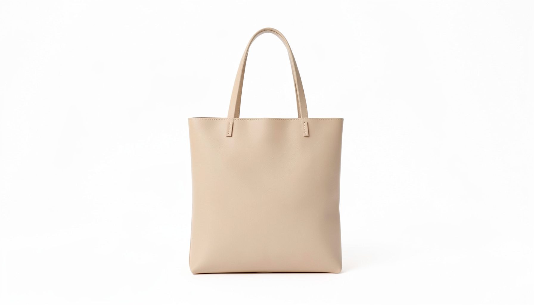 A minimalist beige vegan leather tote bag with slim profile, styled on a white backdrop