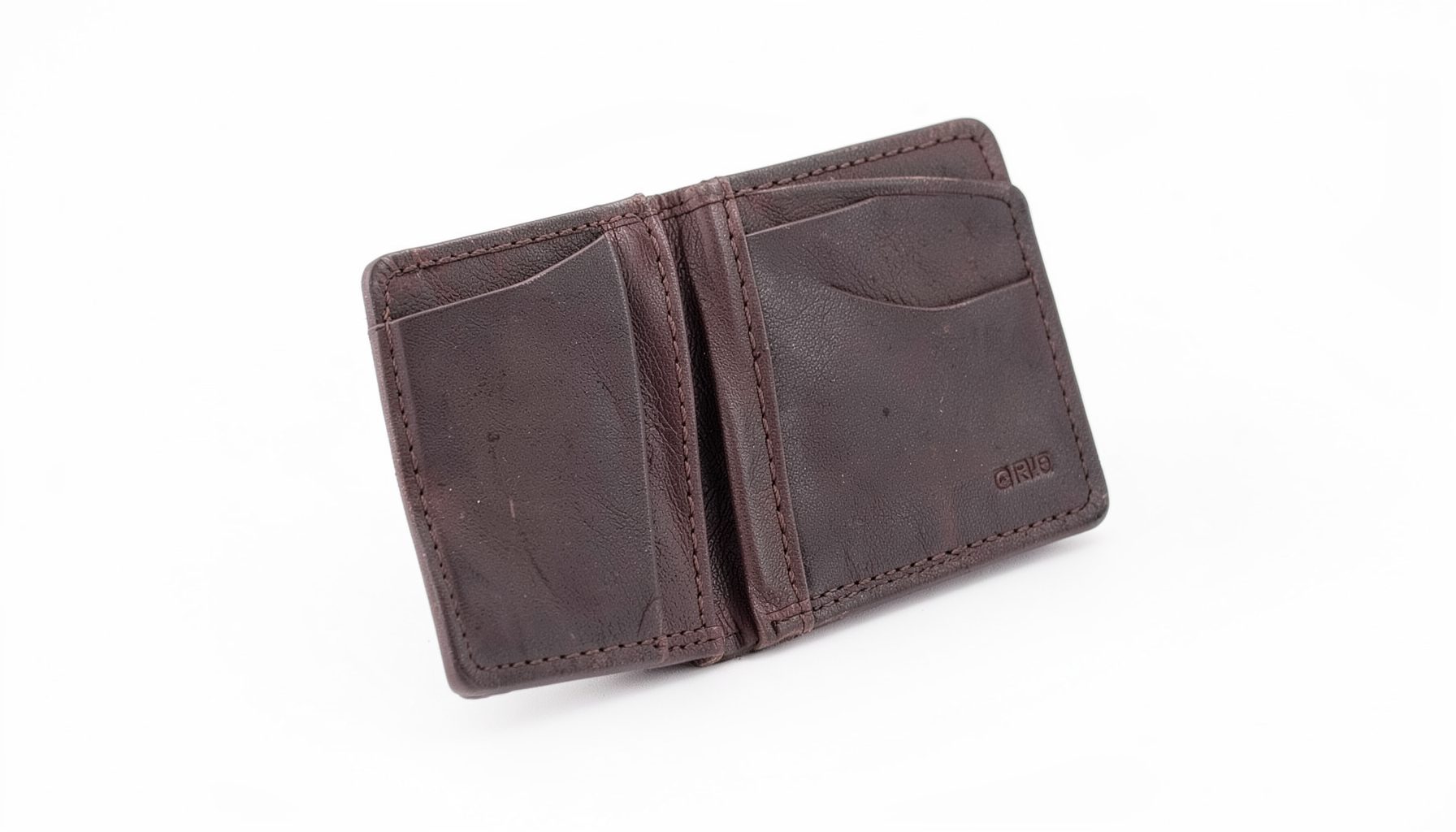 A slim bi-fold vegan leather wallet in deep brown with visible card slots, photographed on a clean white background.