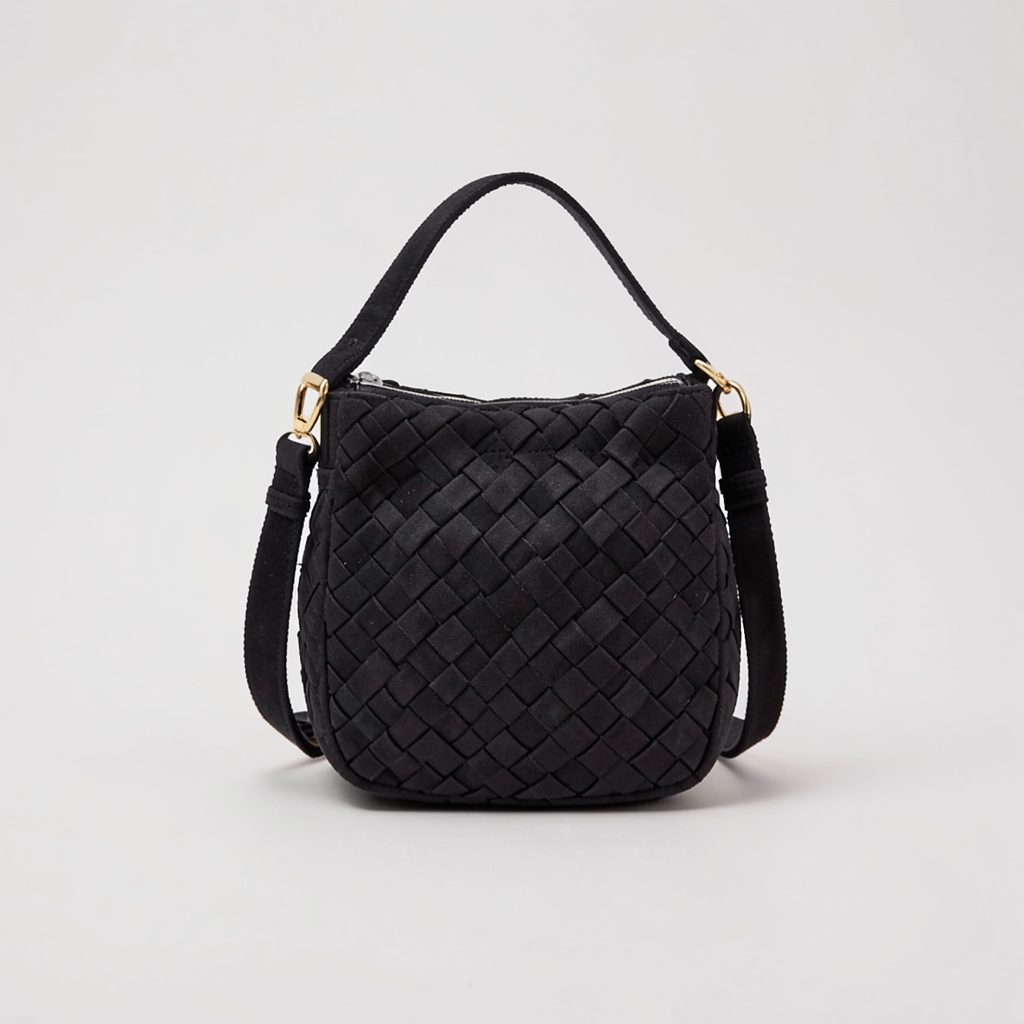 Black woven crossbody bag with a faux suede texture and gold-toned hardware on a plain light backdrop